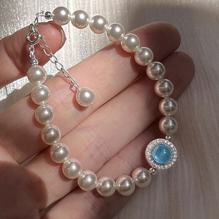 Luxuriöses Armband mit glänzenden Swarovski Kristallperlen und einem runden Aquamarin-Zentrum, eingefasst in 925er Silber
