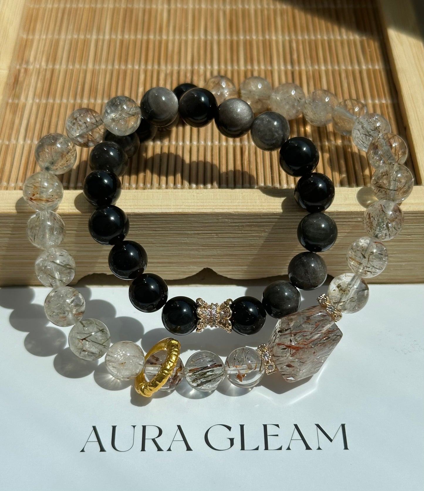 Doppel-Armband im Originaldesign aus Super Seven und schwarzem Goldobsidian, veredelt mit goldfarbenen Akzenten – kraftvolles und elegantes Schmuckstück
