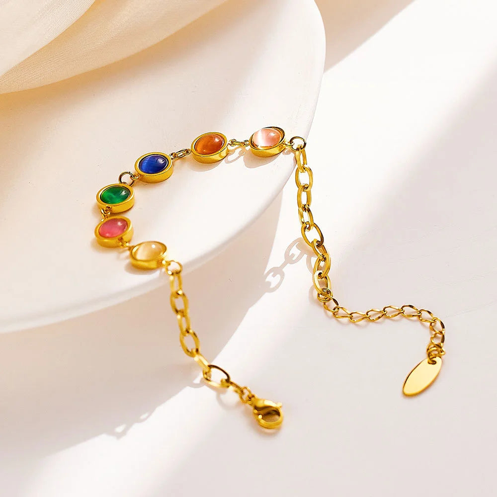 Goldenes Titanstahl-Armband "Iris" mit fünf bunten runden Katzenaugen-Steinen und Verlängerungskette