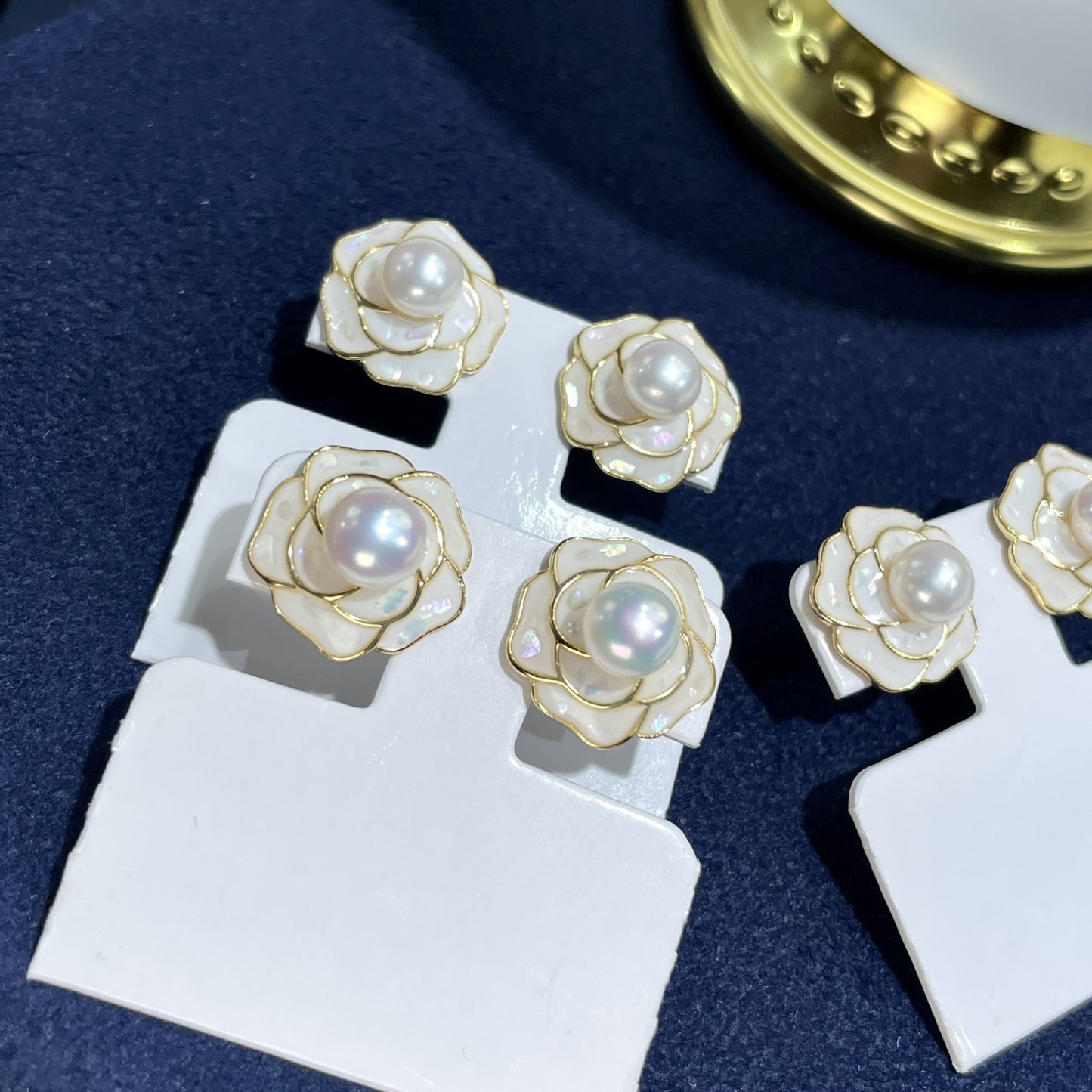 Elegante Ohrstecker in Kamelienform mit schimmernder Süßwasserperle und zartem Perlmutt – gefertigt aus 925er Silber, ideal für romantische Looks
