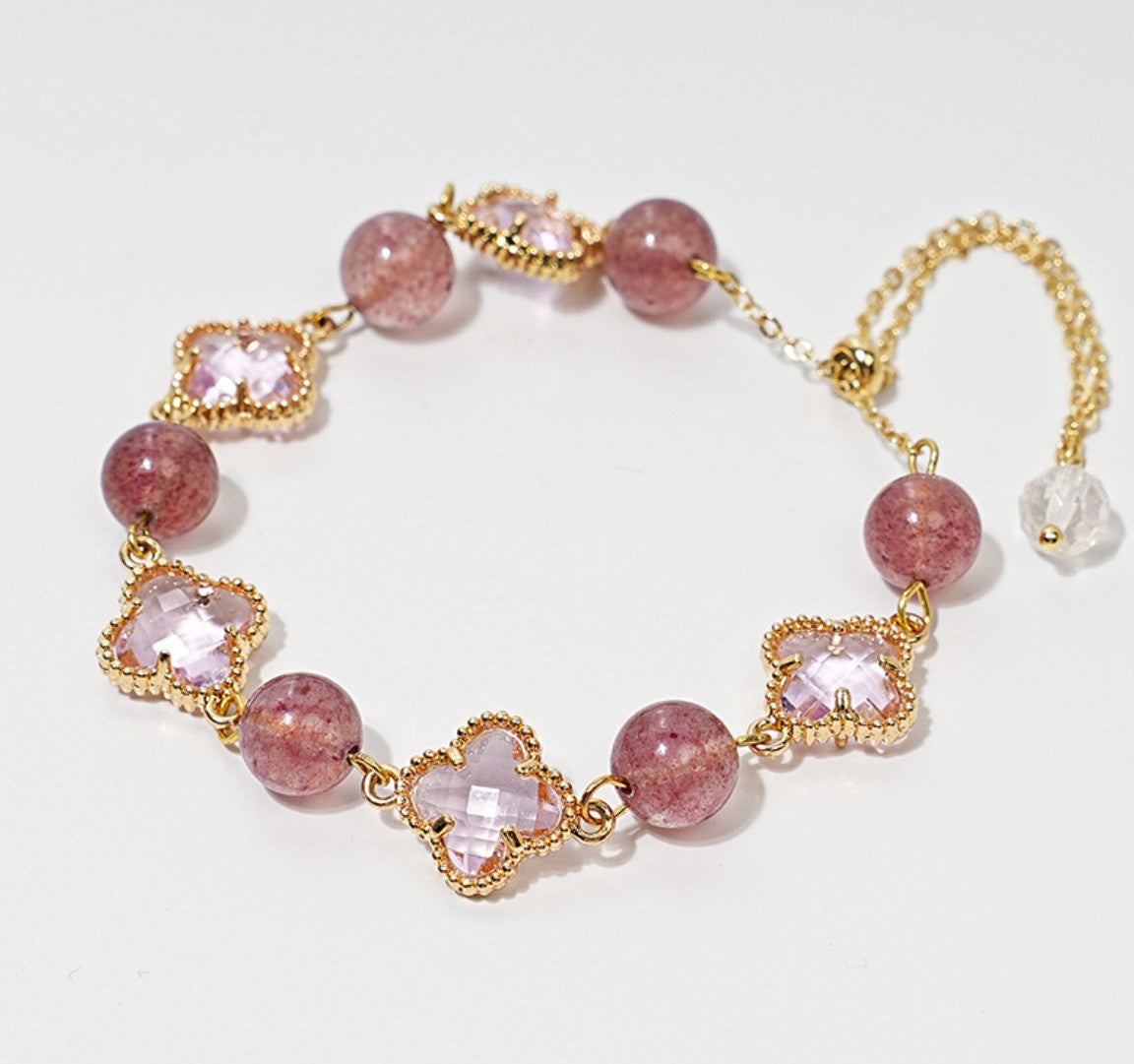 Zartes Armband mit rosa Erdbeerquarz-Perlen und funkelnden Zirkonia-Kleeblättern – romantisches Design mit Goldakzenten