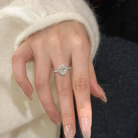 Feine Silberkette mit funkelndem Blütenanhänger aus vier Zirkonia-Steinen auf schwarzem Hintergrund.