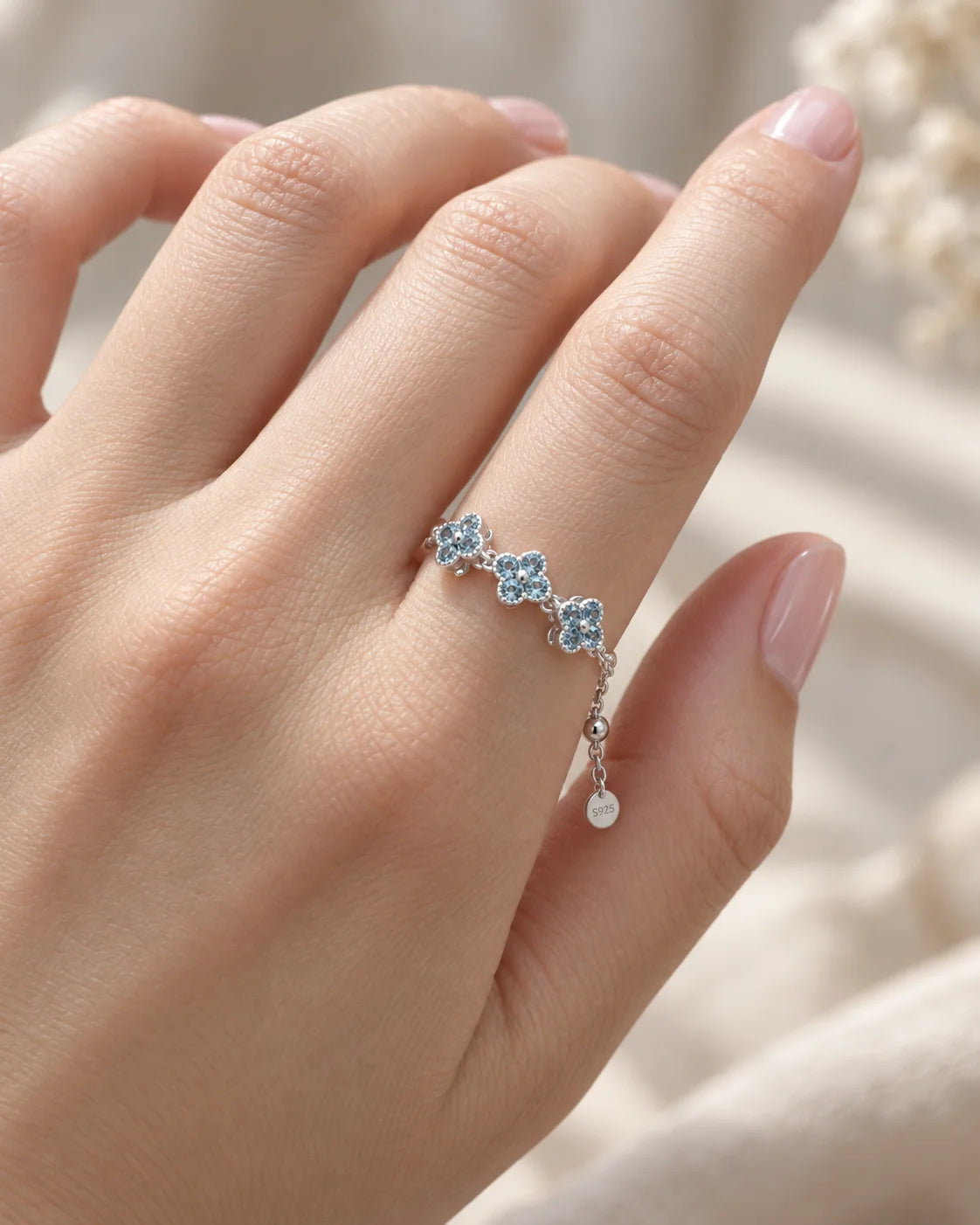 Chloe Kleeblatt Kettenring mit blauen Zirkonia am Finger getragen