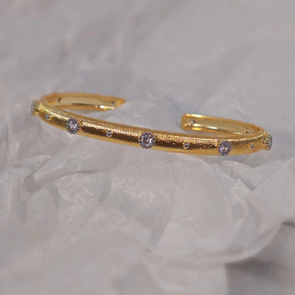 Goldener offener Armreif mit vierblättrigem Kleeblattmuster und Zirkonia, gebürstete Oberfläche, Vintage-Stil