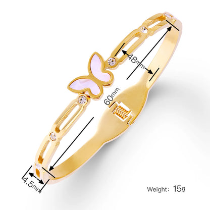 Goldenes Schmetterlingsarmband aus Edelstahl mit Acryl-Inlay und Strass, glänzend vergoldet