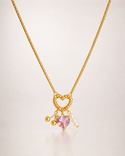 Charm-Halskette aus 18K vergoldetem Titanstahl mit gedrehtem Herz-Ring, rosa Kristallherz, goldenen Kirschen und Perlen-Anhängern