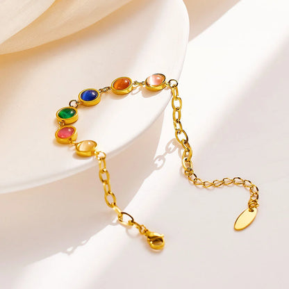 Goldenes Titanstahl-Armband "Iris" mit fünf bunten runden Katzenaugen-Steinen und Verlängerungskette