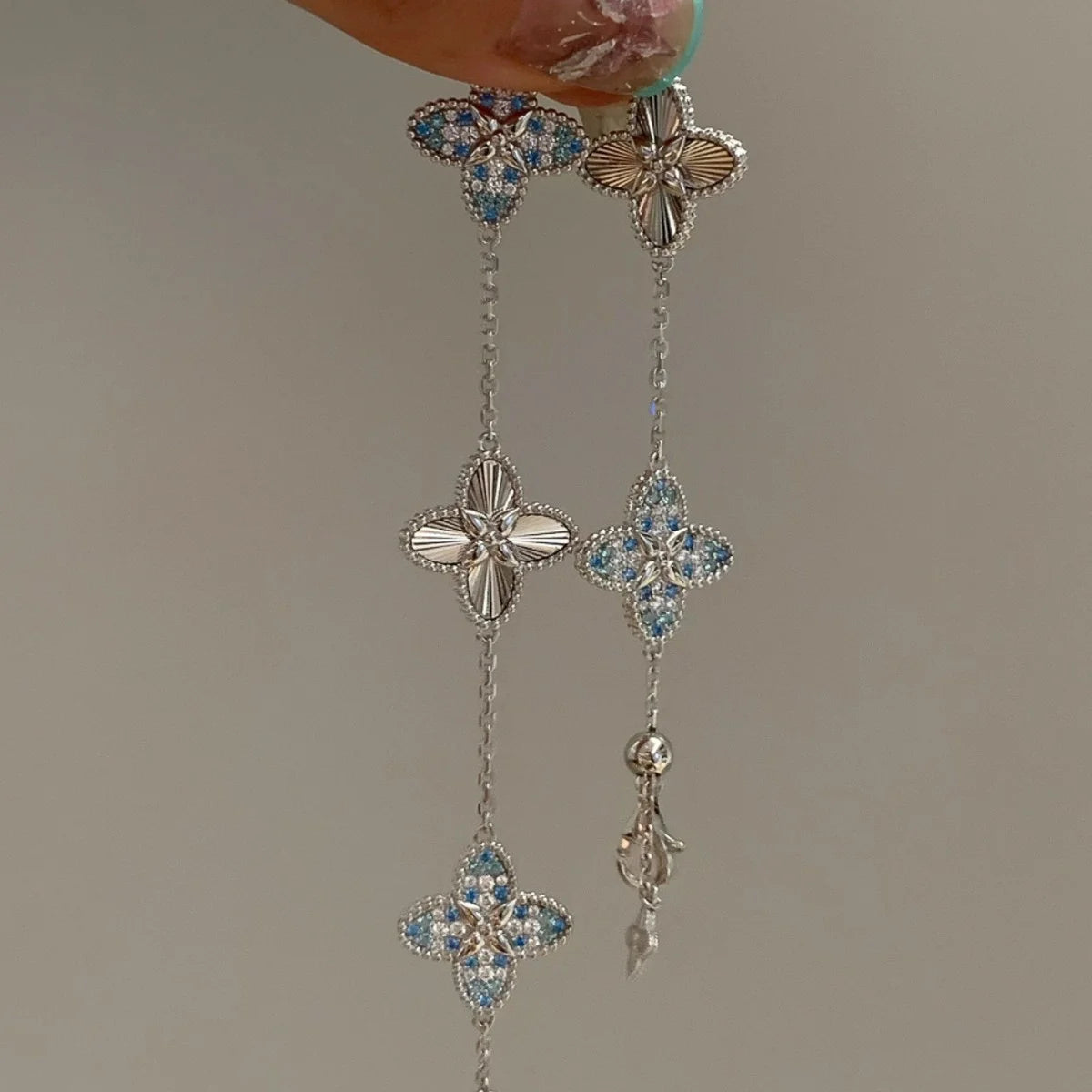 Filigranes versilbertes Armband "Lia" mit fünf Kleeblatt-Motiven, verziert mit hellblauen Zirkonia und Sonnenstrahl-Struktur