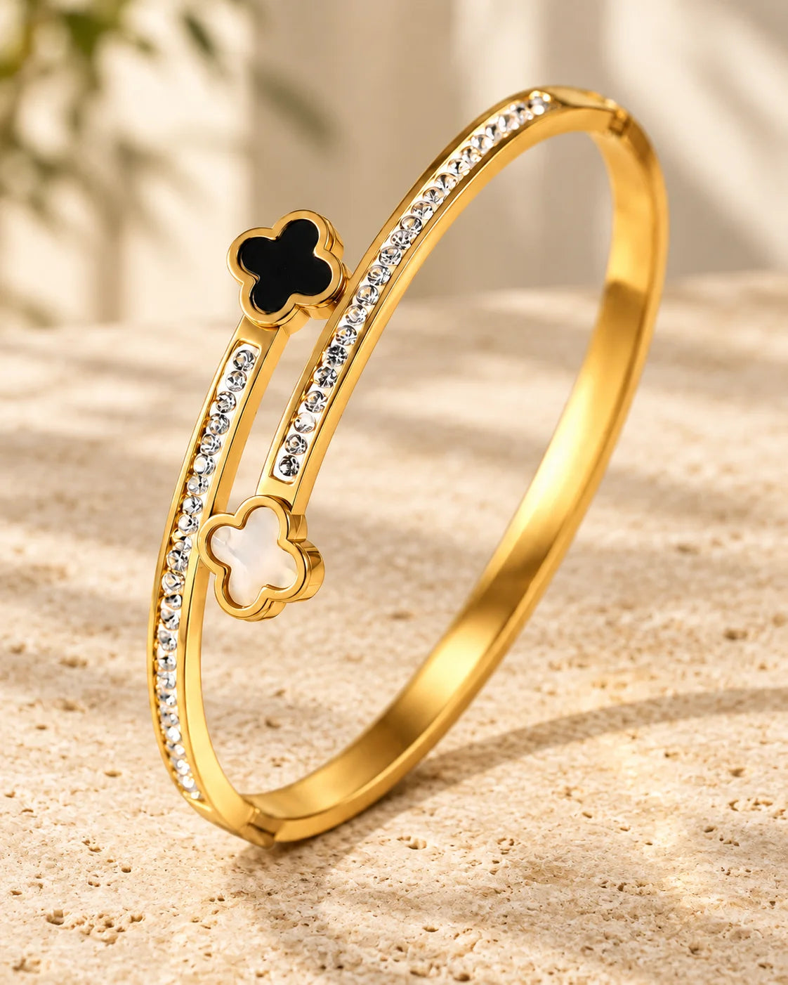 Mila gold-tone clover bangle with black and white motifs