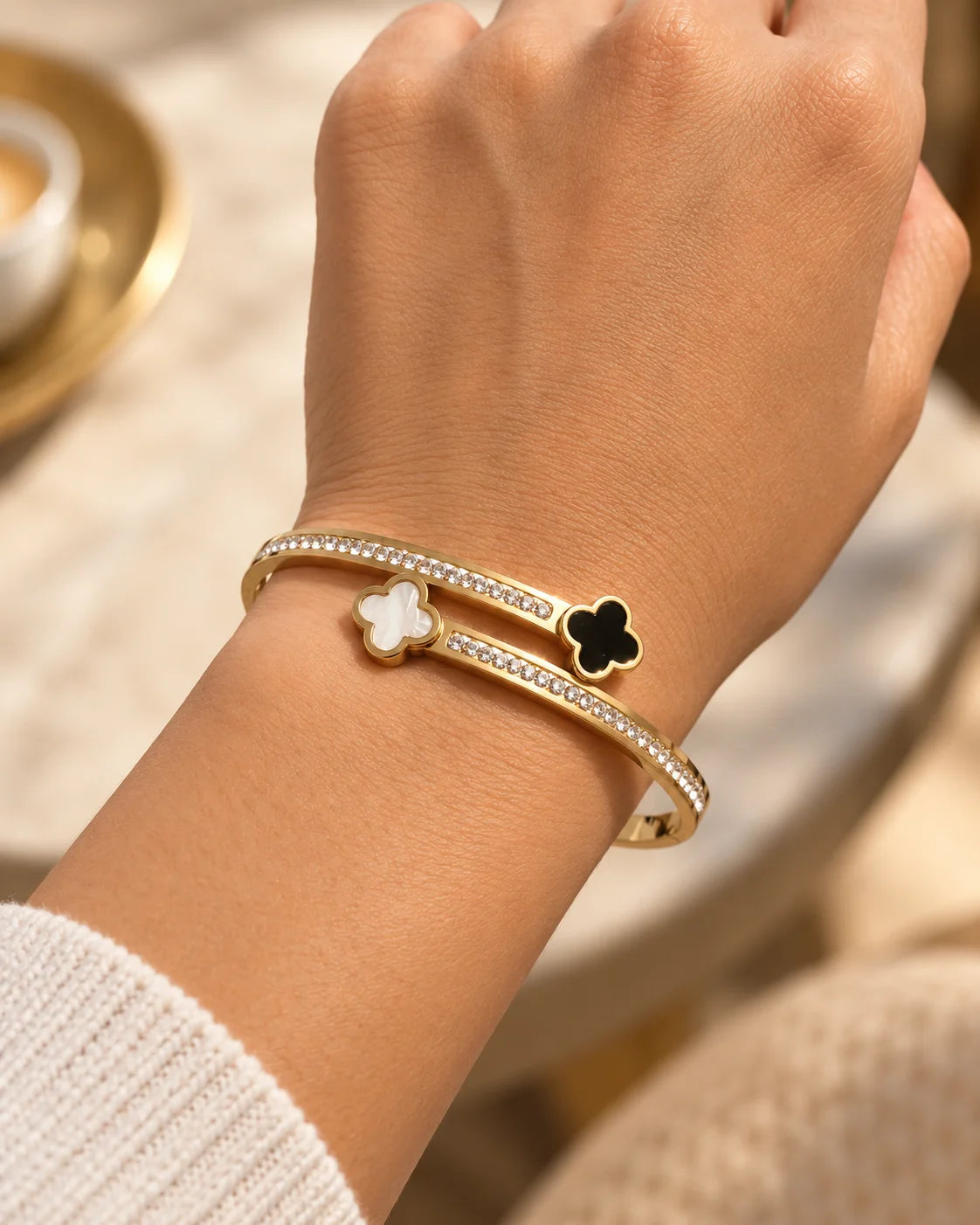 Detail of the Mila clover bangle with double bands and cubic zirconia