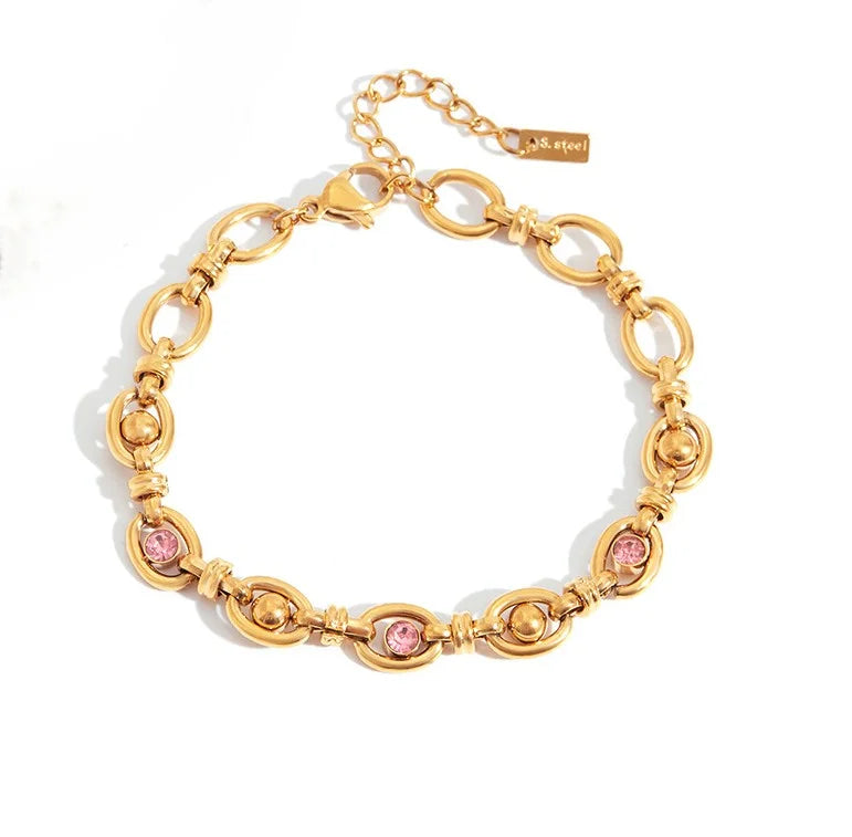 Goldenes Titanstahl-Armband "Sophie" mit ovalen Gliedern, besetzt mit rosa Zirkonia und goldenen Kugeln