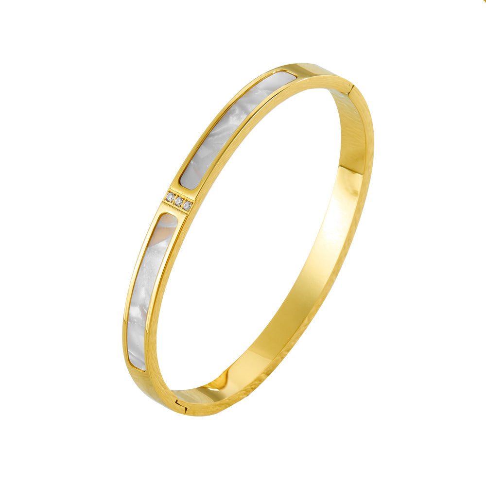 Eleganter vergoldeter Armreif mit rechteckigen Perlmutt-Einlagen und Zirkonia-Akzent