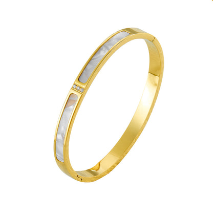 Eleganter vergoldeter Armreif mit rechteckigen Perlmutt-Einlagen und Zirkonia-Akzent