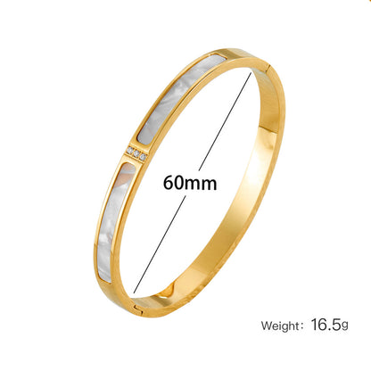 Eleganter vergoldeter Armreif mit rechteckigen Perlmutt-Einlagen und Zirkonia-Akzent