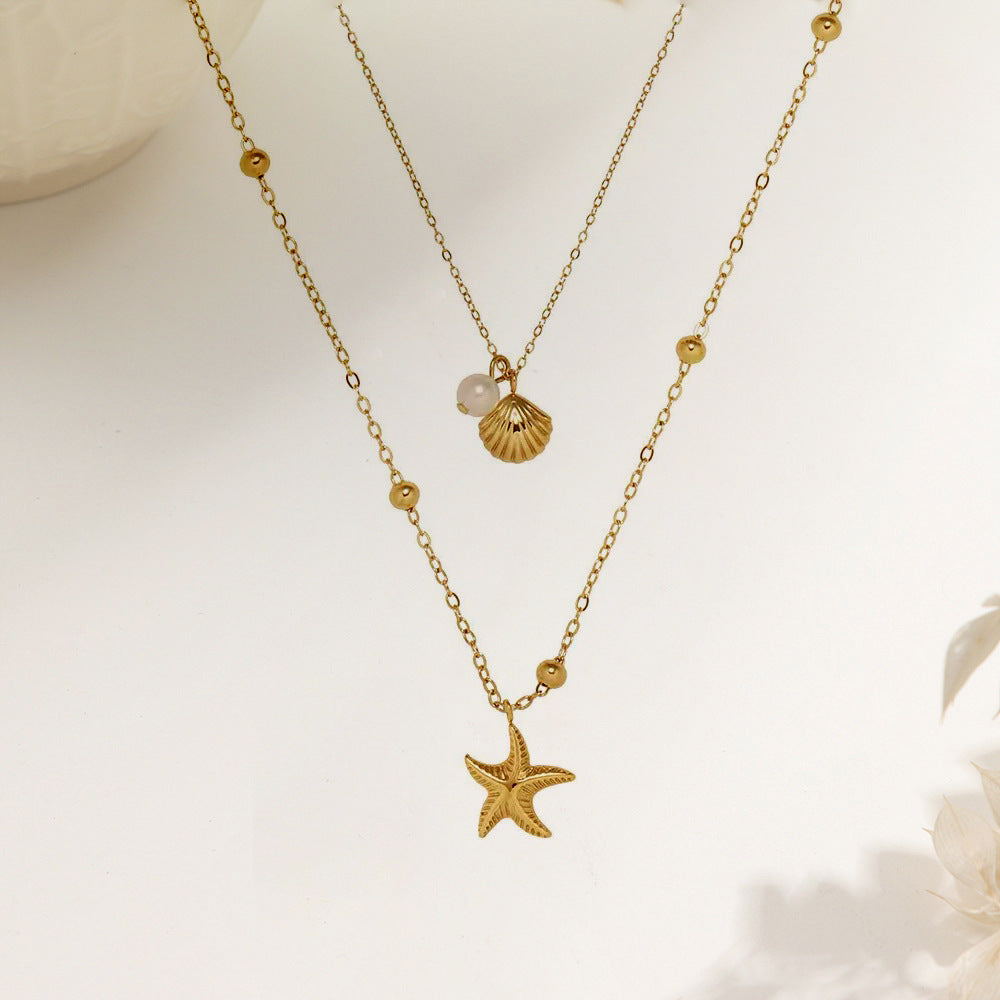 Vergoldete doppellagige Halskette mit Seestern- und Muschelanhänger im maritimen Design.