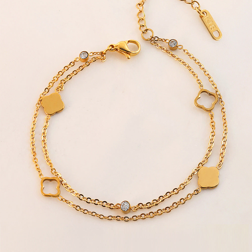 Vergoldetes Doppelarmband mit Kleeblatt- und Zirkonia-Elementen