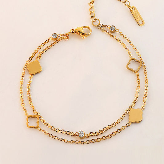 Vergoldetes Doppelarmband mit Kleeblatt- und Zirkonia-Elementen