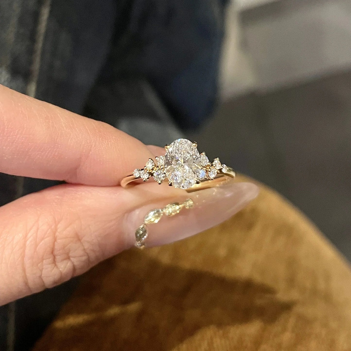 Goldener Ring mit großem funkelnden ovalen Zirkonia und seitlichen Steinen