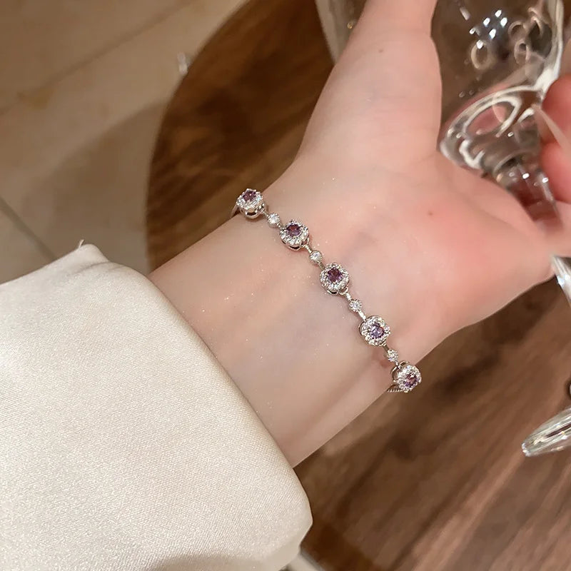 Zartes versilbertes Armband "Viola" mit fünf lavendelfarbenen, von Kristallen umrahmten Zirkonia-Steinen auf weißem Untergrund