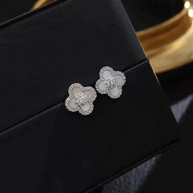 Silberne Ohrstecker in Blütenform mit weißer Einlage und Zirkonia