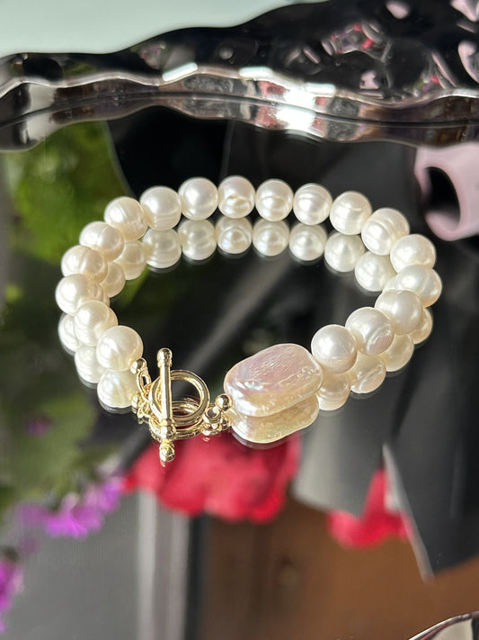 Elegantes Perlenarmband mit schimmernden Süßwasserperlen, verziert mit einem flachen Barockquadrat und hochwertigem OT-Verschluss – klassische Schönheit in moderner Form